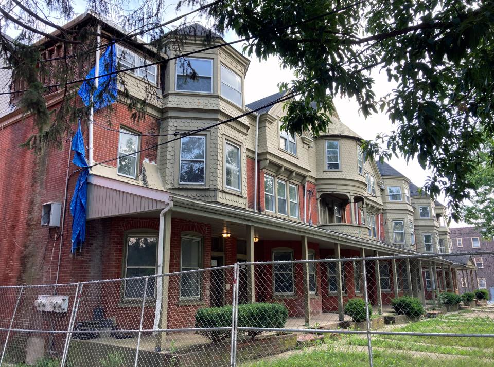 A stretch of apartment buildings on the 800 block of N. Adams Street remains vacant and behind fencing as significant repairs appear to still be needed before the buildings are considered habitable, seen Wednesday, July 5, 2023.