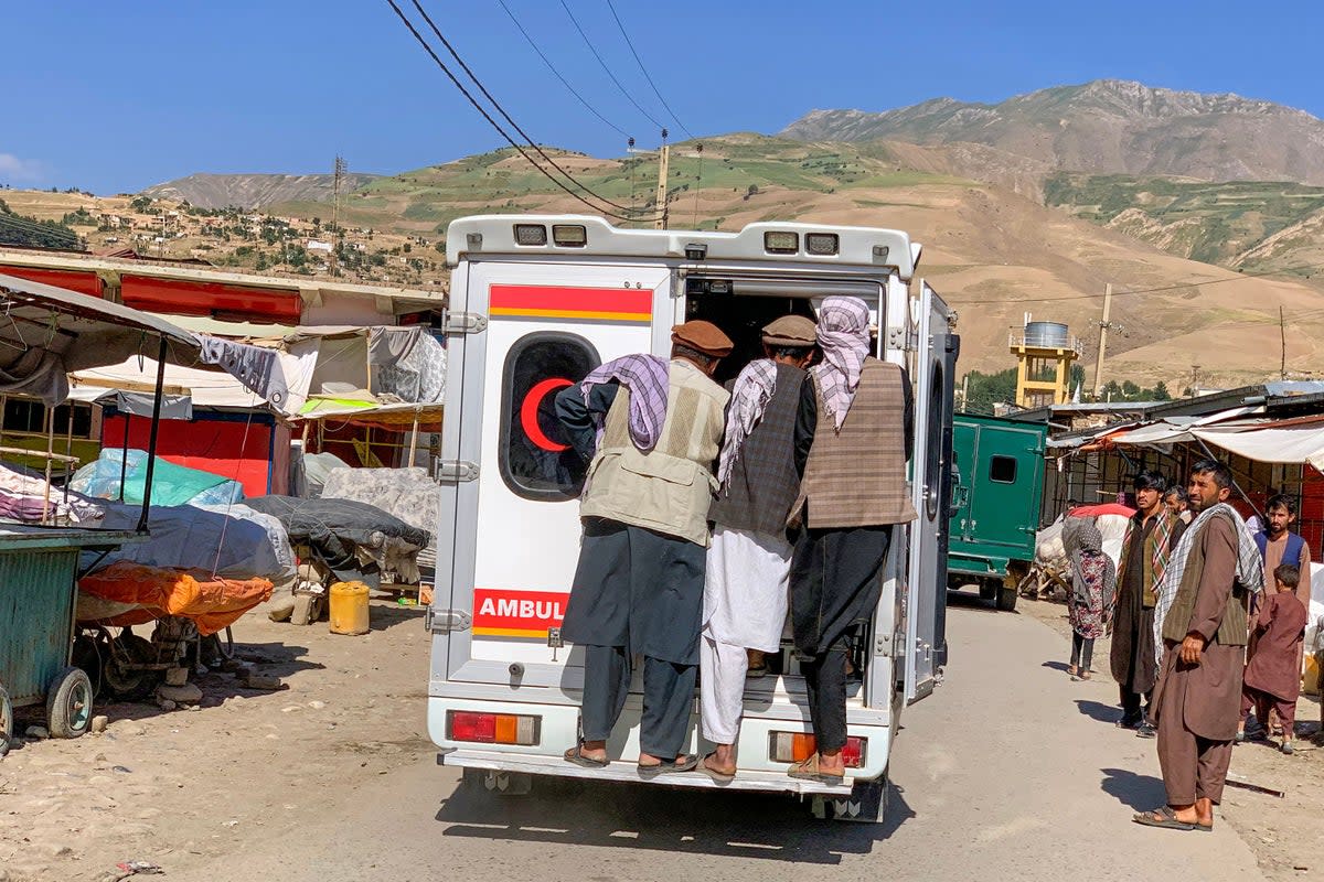 Relatives carry the bodies of slain victims in an ambulance after a bomb explosion during Fatiha prayers at the Nabawi mosque in the Hesa-e-Awal area of Fayzabad district, Badakhshan province (AFP via Getty Images)