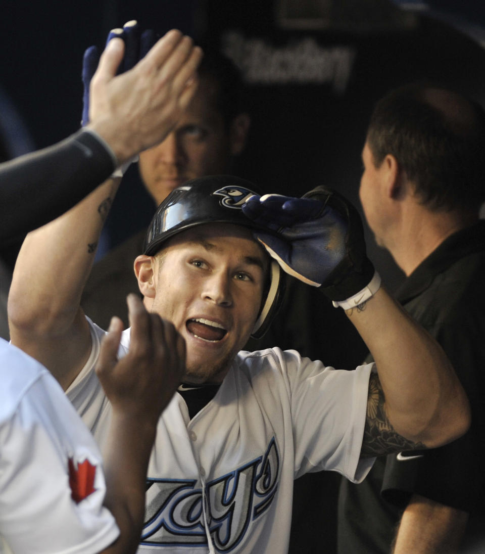 TORONTO, CANADA - AUGUST 26: Brett Lawrie #13 of the Toronto Blue Jays celebrates his home run with teammates during MLB game action against the Tampa Bay Rays August 26, 2011 at Rogers Centre in Toronto, Ontario, Canada. (Photo by Brad White/Getty Images)