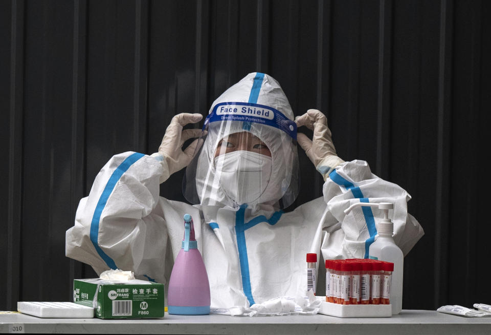 A health worker wearing a protective suit 