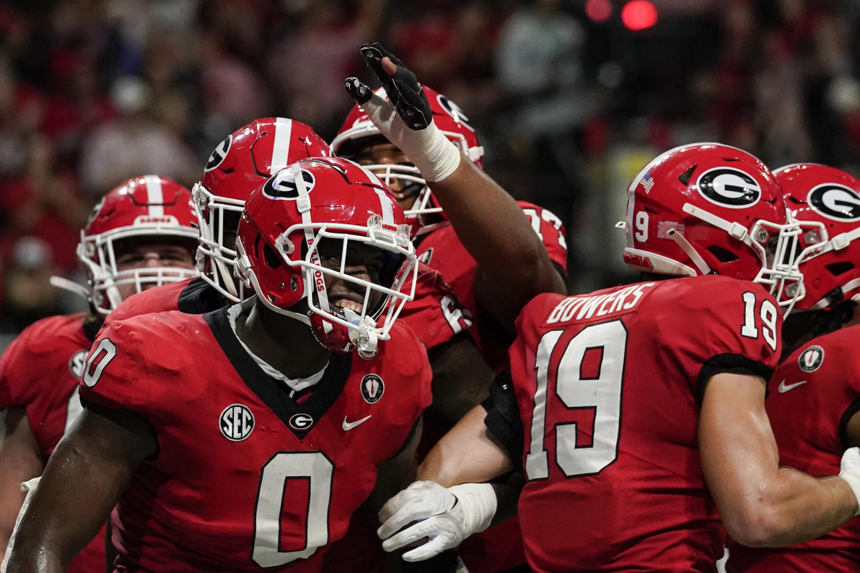 Georgia tight end Darnell Washington (0) celebrates after scoring a touchdown in the first half of the Southeastern Conference championship NCAA college football game, Saturday, Dec. 3, 2022, in Atlanta. (AP Photo/Brynn Anderson)