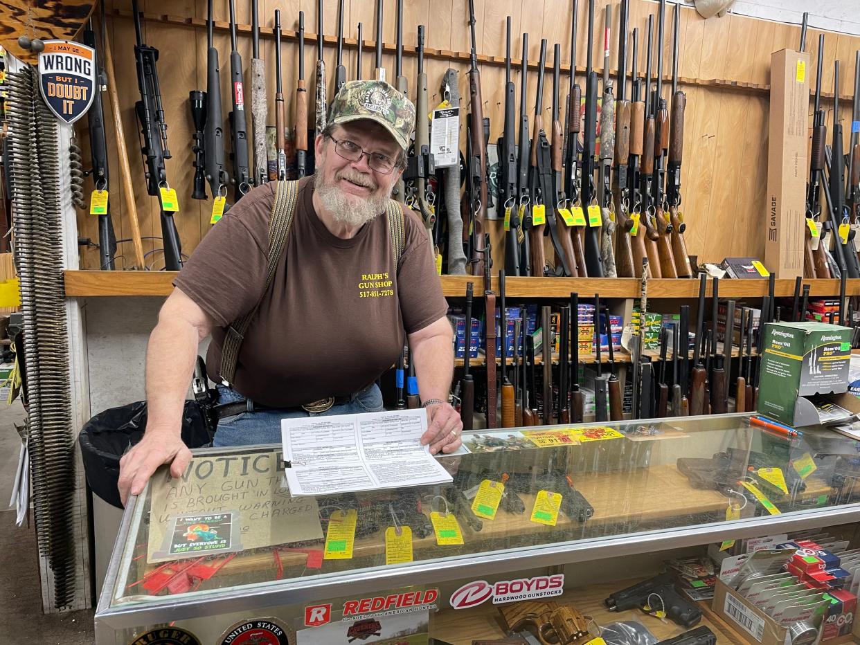 Ralph Myer talks about the state's pistol sales form behind the counter of his Stockbridge firearms store, Ralph's Gun Shop, Friday, March 10, 2023.