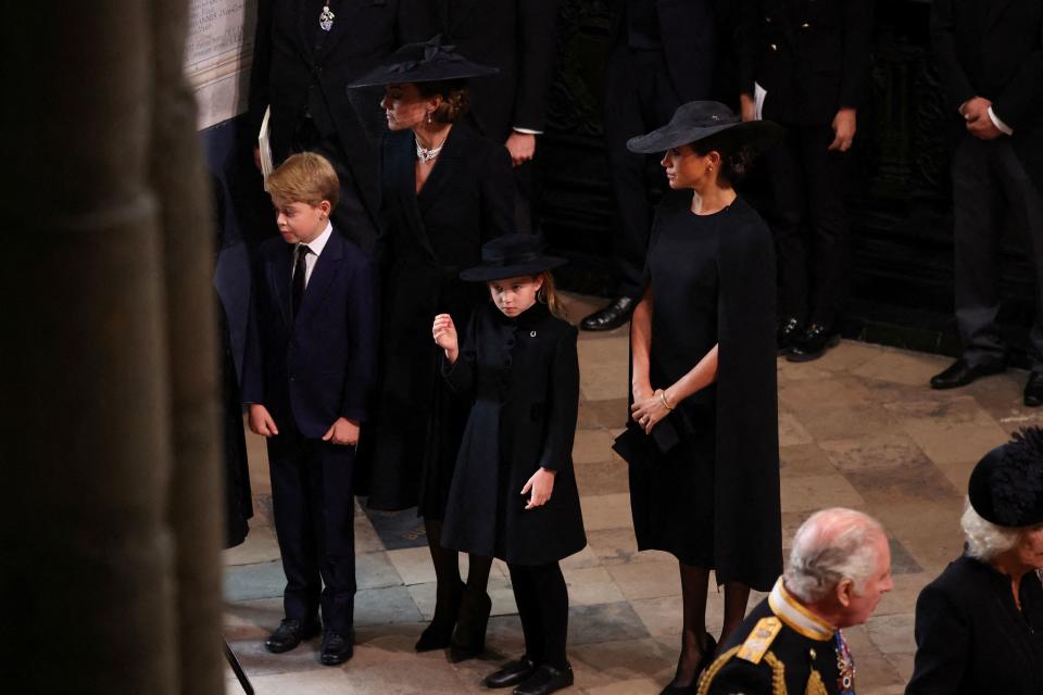 Britain's Catherine (2L), Princess of Wales, Meghan (2R), Duchess of Sussex, Prince George (L), Princess Charlotte (C), Britain's King Charles III (R) and Britain's Camilla, Queen Consort attend the state funeral and burial of Britain's Queen Elizabeth, at Westminster Abbey in London, Britain, September 19, 2022. (Photo by PHIL NOBLE / POOL / AFP) (Photo by PHIL NOBLE/POOL/AFP via Getty Images)