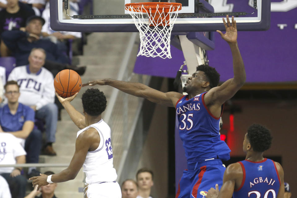 TCU guard RJ Nembhard (22) scores on a reverse layup against Kansas center Udoka Azubuike (35) during the second half of an NCAA college basketball game, Saturday, Feb. 8, 2020 in Fort Worth, Texas. Kansas won 60-46. (AP Photo/Ron Jenkins)