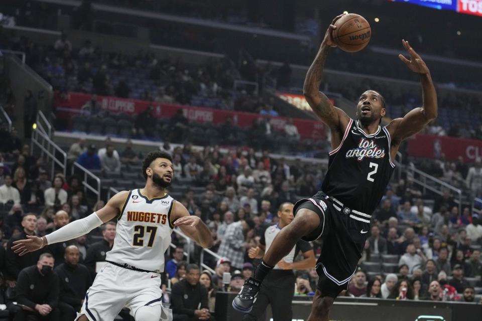 Los Angeles Clippers forward Kawhi Leonard (2) scores past Denver Nuggets guard Jamal Murray (27) during the first half of an NBA basketball game Friday, Jan. 13, 2023, in Los Angeles. (AP Photo/Marcio Jose Sanchez)