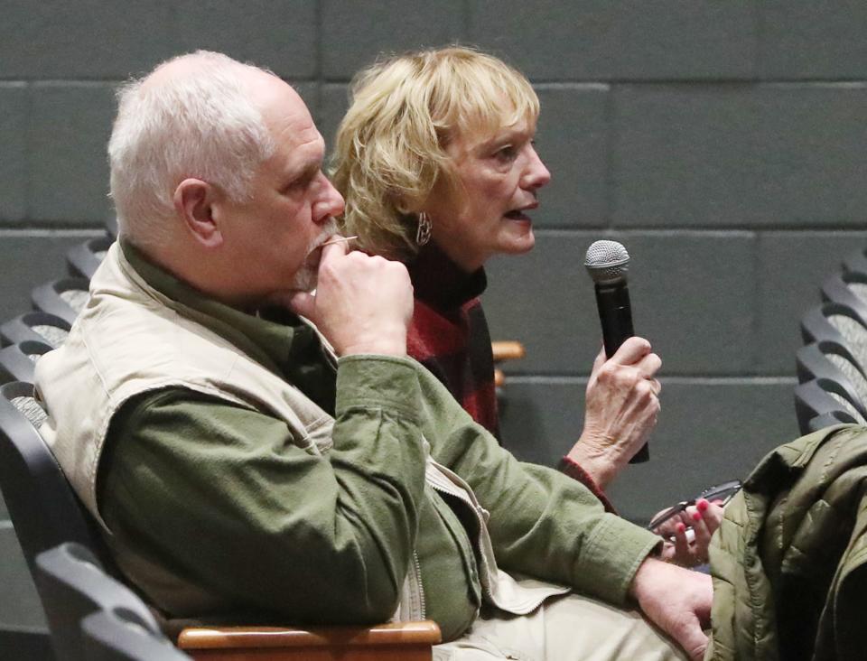 Sylvia Trundle, retired Akron Police captain, sitting with her husband, Marc, asks a question of Anthony Finnell, the Akron Citizens' Police Oversight Board pick for the position of police auditor, during a town hall hosted by the board Wednesday at Ellet Community Learning Center.