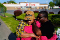 People embrace at the scene of Saturday's shooting at a supermarket, in Buffalo, Thursday, May 19, 2022. (AP Photo/Matt Rourke)