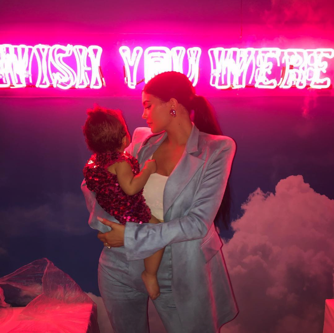 Kylie Jenner posted a photo in front of a neon sign at daughter Stormi Webster’s first birthday party, writing she “had to go all out for my baby.” (Credit: Kylie Jenner via Instagram)