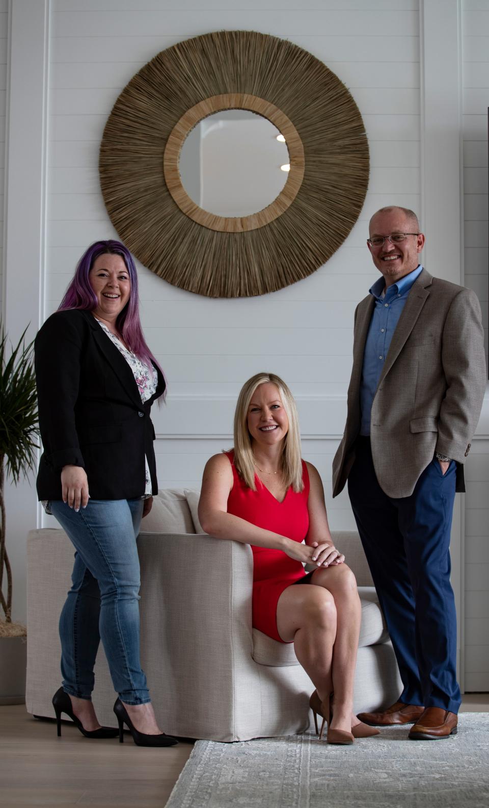 From left, Bess Charles, owner of LadyCakes Bakery, Megan Rose, founder and CEO of nonprofit "Better Together," and Bryan Blackwell, managing partner at Southern Oak Wealth Management, pose for a portrait in Cape Coral last month.