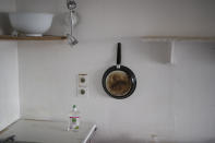 In this photo taken on Dec.15, 2019 a frying pan hangs in a communal kitchen in the intern residency at Marseille's La Timone hospital, southern France. In a hospital in Marseille, student doctors are holding an exceptional, open-ended strike to demand a better future. France’s vaunted public hospital system is increasingly stretched to its limits after years of cost cuts, and the interns at La Timone - one of the country’s biggest hospitals - say their internships are failing to prepare them as medical professionals. Instead, the doctors-in-training are being used to fill the gaps. (AP Photo/Daniel Cole)