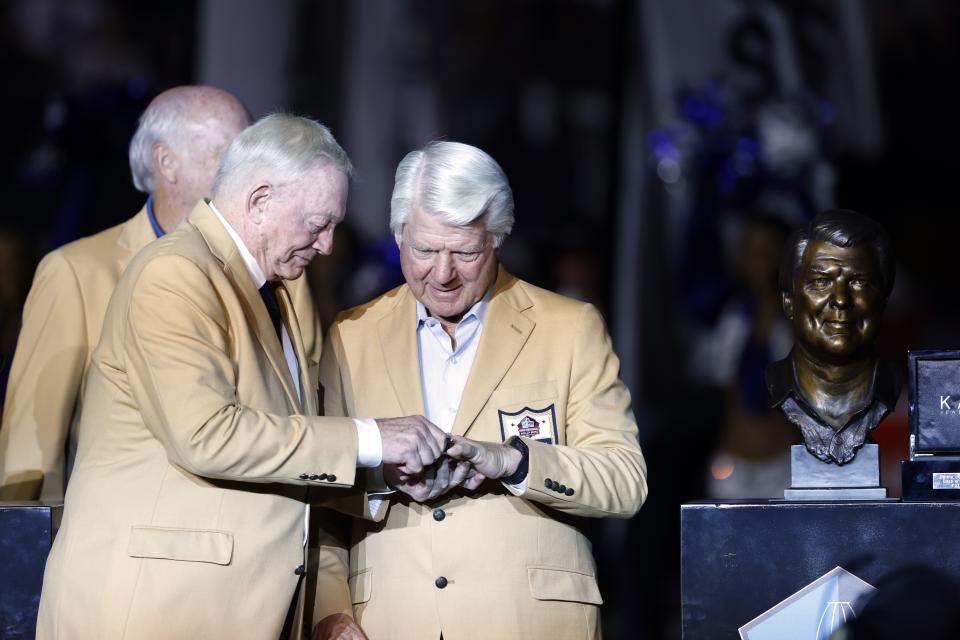 Dallas Cowboys team owner Jerry Jones honors former coach Jimmy Johnson for his Hall Of Fame induction during a halftime ceremony of an NFL football game between the Philadelphia Eagles and Dallas Cowboys in Arlington, Texas, Monday, Sept. 27, 2021. (AP Photo/Ron Jenkins)