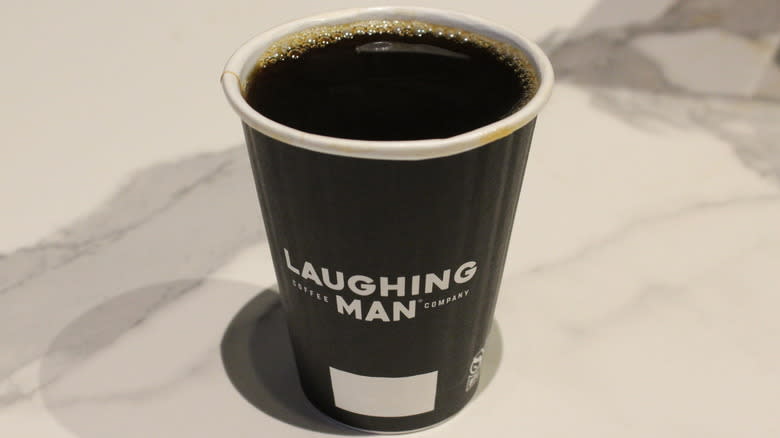 Paper cup of black coffee at Laughing Man