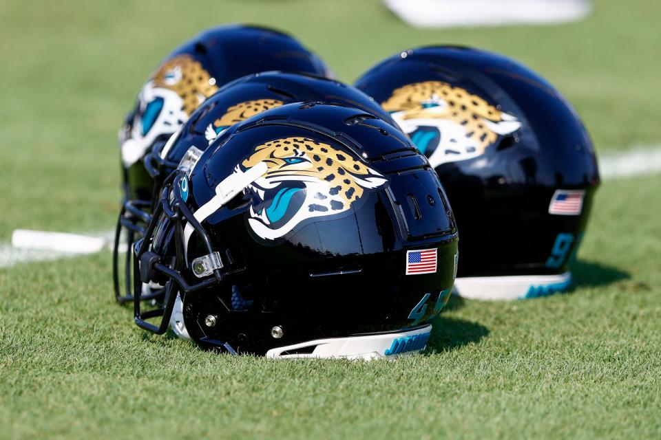 Jul 28, 2021; Jacksonville, FL, USA; Jacksonville Jaguars helmets lay next to the field prior to the start of training camp at Dream Finders Homes practice field Mandatory Credit: Nathan Ray Seebeck-USA TODAY Sports
