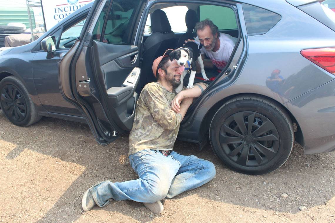 James “Mac” Benton reunites with his dog Patches on Sunday, July 31, 2022, after fleeing the McKinney Fire as it burned through his Klamath River neighborhood two days earlier. Benton was unable to corrale patches and three other pets into his motor home before the fire intensity forced him to flee. Patches, singed but alive, was found the following morning by a photographer who was surveying the wreckage.