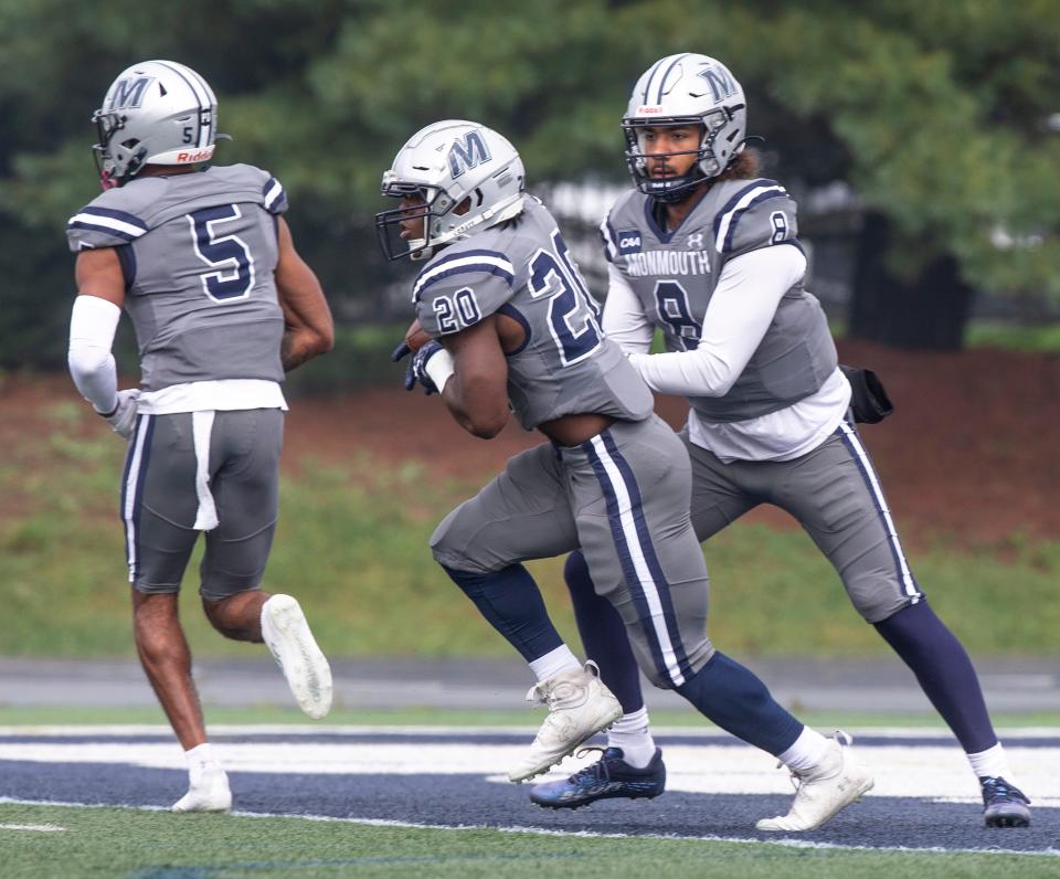 Monmouth quarterback Marquez McCray (8) hands the ball to running back Jaden Shirden (20) during Monmouth's win over Lehigh in West Long Branch on Sept. 30, 2023.