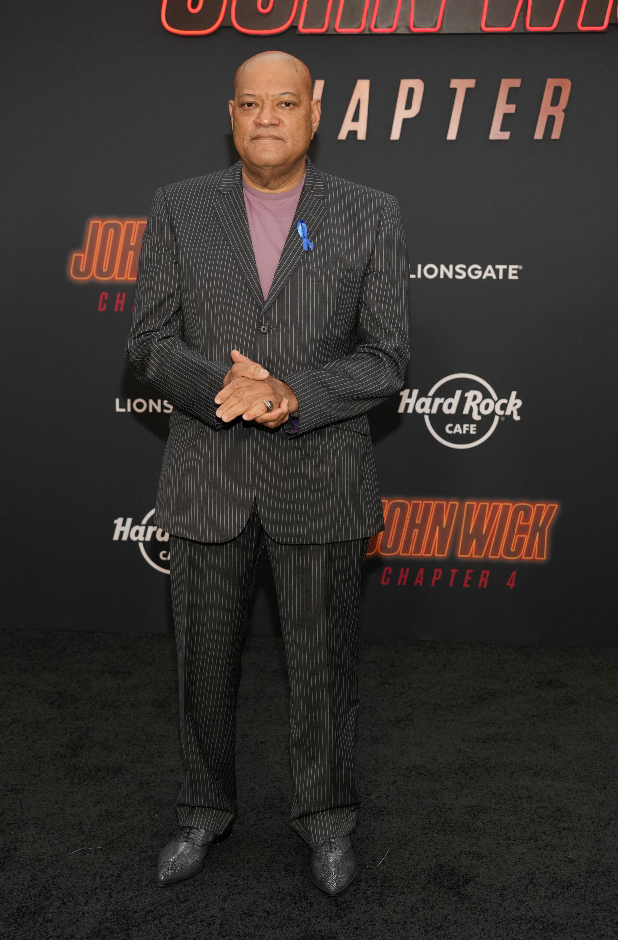 Laurence Fishburne, a cast member in "John Wick: Chapter 4," poses at the premiere of the film, Monday, March 20, 2023, at the TCL Chinese Theatre in Los Angeles. (AP Photo/Chris Pizzello)
