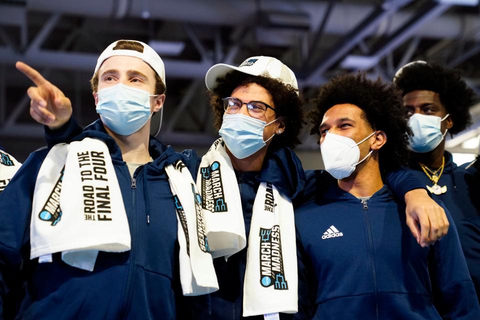 (from left) Saint Peter's players Doug Edert, Daryl Banks and Matthew Lee watch the highlights of their NCAA tournament wins during a celebration at the university campus in Jersey City on Sunday, March 20, 2022.