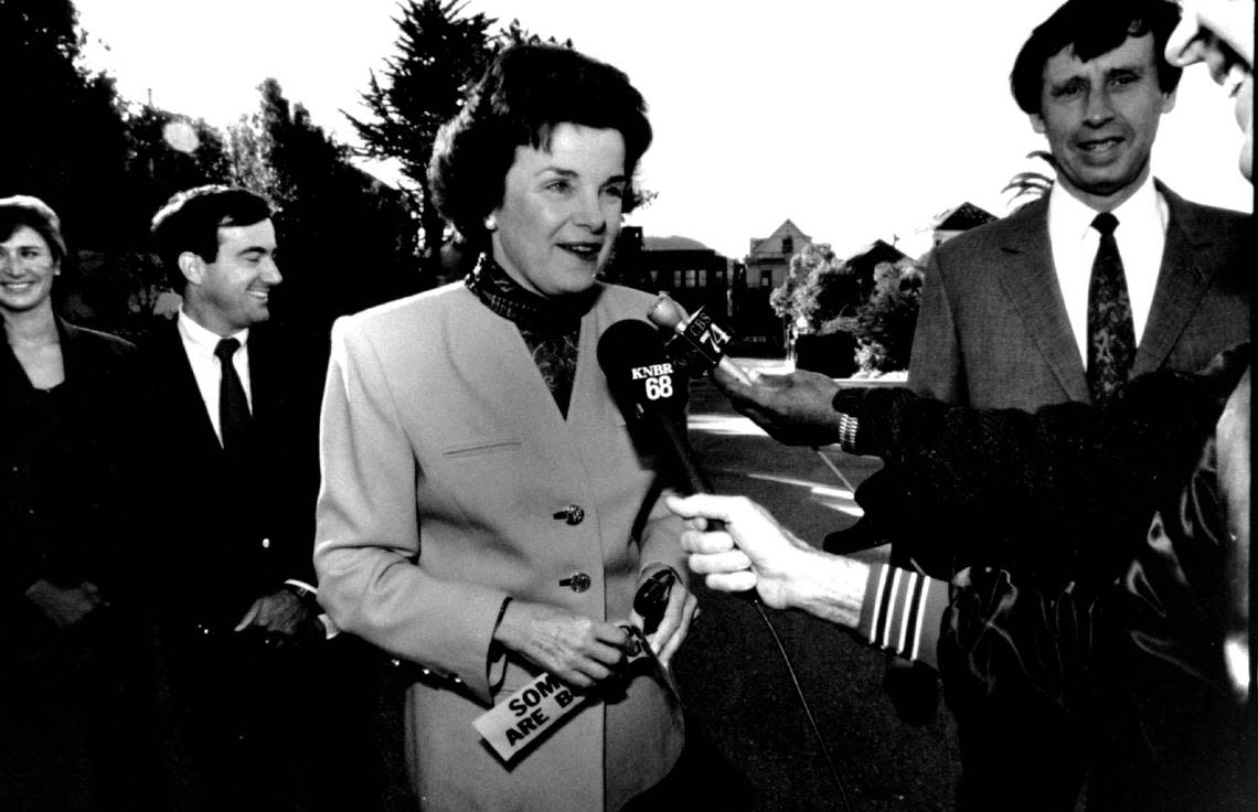 Dianne Feinstein, Democratic candidate for governor, talks with reporters Nov. 6, 1990, in San Francisco on her way to the polls. Her husband Richard Blum stands at right.