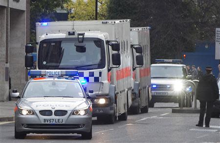 A police convoy of prison vans arrives at the Old Bailey, in London November 29, 2013. REUTERS/Neil Hall