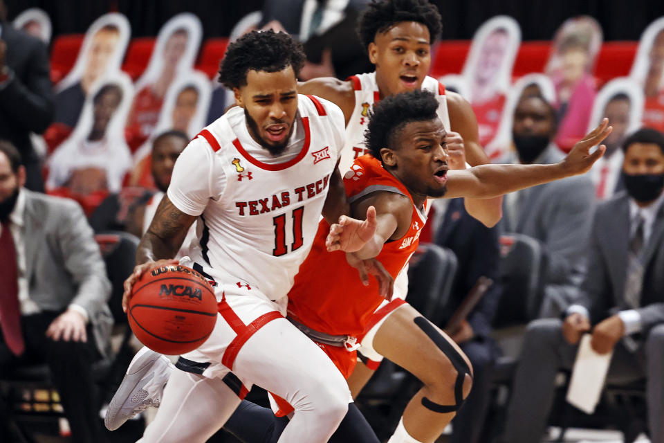 Texas Tech's Kyler Edwards (11) dribbles the ball past Sam Houston State's Bryce Monroe (0) during the first half of an NCAA college basketball game Friday, Nov. 27, 2020, in Lubbock, Texas. (AP Photo/Brad Tollefson)