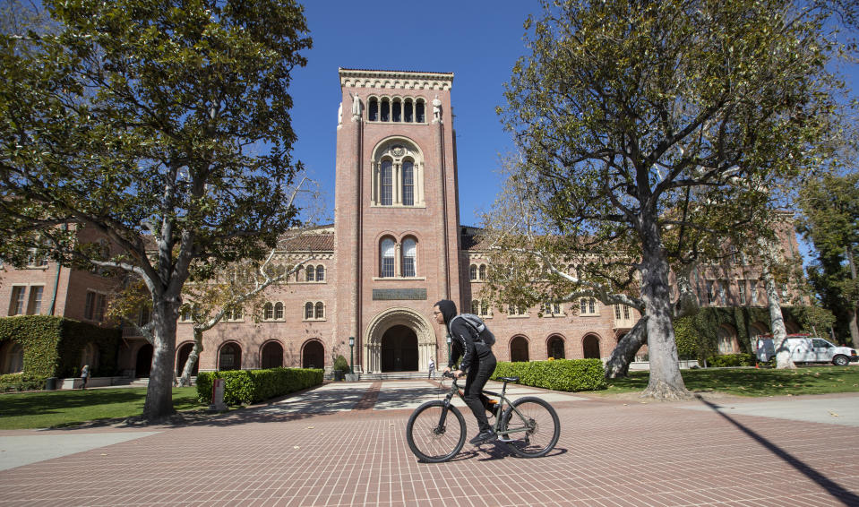 LOS ANGELES, CALIFORNIA - MARCH 12:   A view of people visiting the University of Southern California on March 12, 2019 in Los Angeles, California. Federal prosecutors say their investigation dubbed Operation Varsity Blues blows the lid off an audacious college admissions fraud scheme aimed at getting the children of the rich and powerful into elite universities. According to prosecutors, wealthy parents paid a firm to help their children cheat on college entrance exams and falsify athletic records of students to enable them to secure admission to schools such as UCLA, USC, Stanford, Yale and Georgetown. Two USC athletic department employees a high-ranking administrator and a legendary head coach were fired Tuesday after being indicted in federal court in Massachusetts for their alleged roles in a racketeering conspiracy that helped students get into elite colleges and universities by falsely designating them as recruited athletes.  (Photo by Allen J. Schaben / Los Angeles Times via Getty Images)