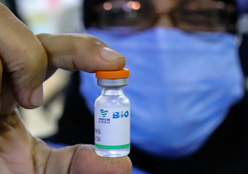 FILE - In this March 3, 2021 file photo, a health worker holds a vial of the Sinopharm COVID-19 vaccine during the vaccination of health personnel, at a clinic in Basra, Iraq. Egypt on Saturday, March 20, received a second shipment of coronavirus vaccine donated by China, officials said, as the country tries to speed up its vaccination campaign. The 300,000-dose shipment of the vaccine manufactured by China's state-owned pharmaceutical giant Sinopharm arrived at Cairo’s international airport early Saturday, according to the Health Ministry. (AP Photo/Nabil al-Jurani, File)