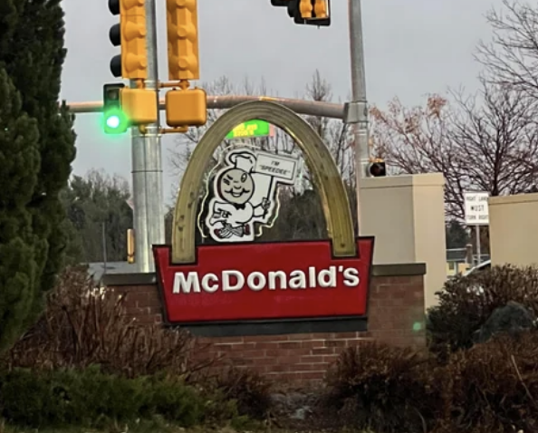 single arch on mcdonald's sign with circle-faced mascot