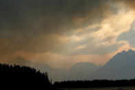 <p>Smoke from a wildfire shrouds mountain peaks in Grand Teton National Park, Wyo., Aug. 24, 2016. (AP Photo/Brennan Linsley) </p>