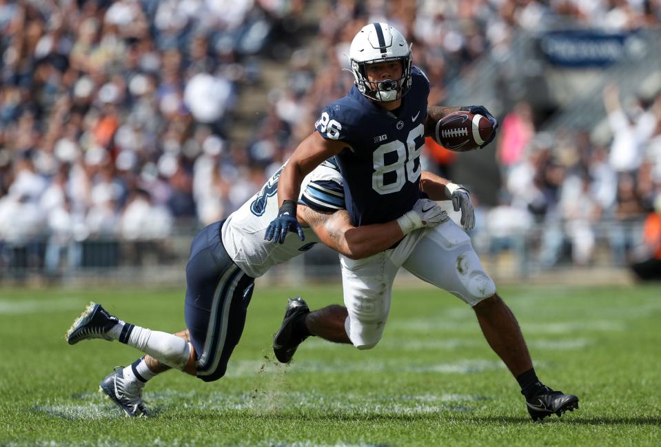 Penn State Nittany Lions tight end Brenton Strange (86) runs with the ball while trying to avoid a tackle from Villanova Wildcats linebacker Forrest Rhyne (43) during the third quarter at Beaver Stadium on Sept. 25, 2021. Penn State defeated Villanova 38-17.