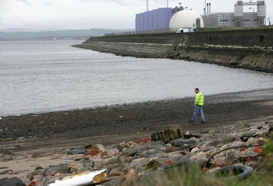 A Scottish Water official examines Seafield beach and the outflow pipe where raw sewage was pumped into the Forth Estuary (Toby Williams/PA) (PA Archive)