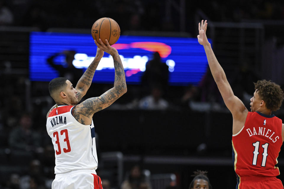 Washington Wizards forward Kyle Kuzma (33) shoots the ball for a 3-point basket against New Orleans Pelicans guard Dyson Daniels (11) during the first quarter of an NBA basketball game, Monday, Jan. 9, 2023, in Washington. (AP Photo/Terrance Williams)