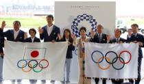 Tokyo governor Yuriko Koike (4th R), Japanese Olympic Committee (JOC) President Takeda Tsunekazu (3rd R), Japan's Olympic team's sub-captain Keisuke Ushiro (3rd L) and captain Saori Yoshida (4th L) pose with the Olympic flag (R) and JOC flag during a ceremony to mark the arrival of the Olympic flag at Haneda airport in Tokyo, Japan, August 24, 2016. REUTERS/Kim Kyung-Hoon