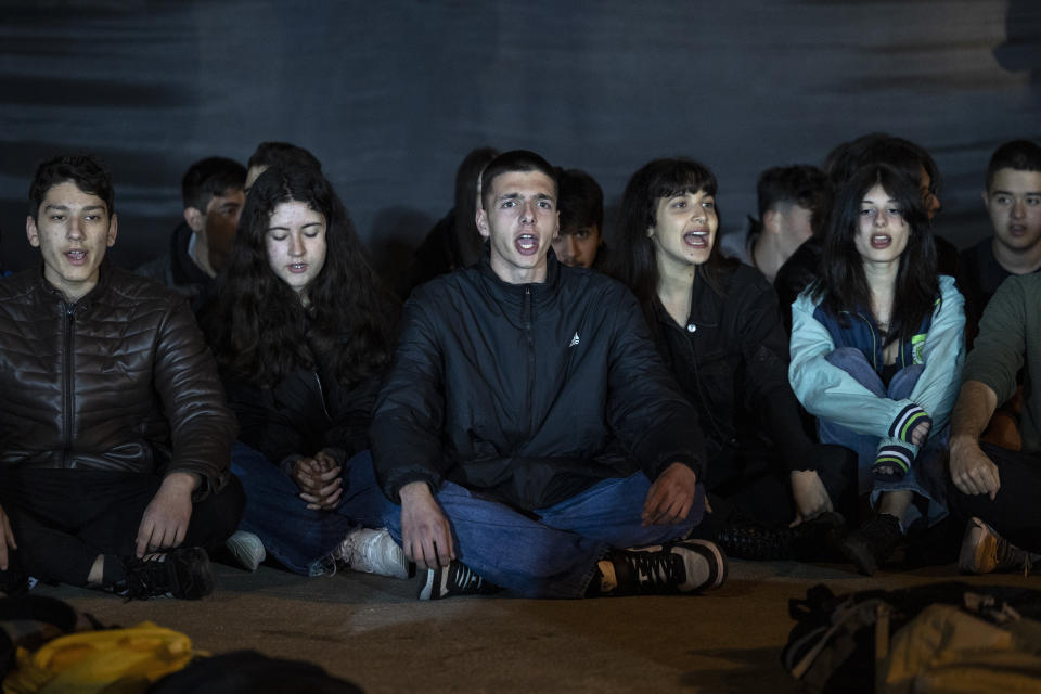 Youths shout slogans during a protest in front of the parliament, in Athens, Saturday, March 4, 2023. Supporters of the Greek Communist party gathered to protest the deaths of dozens of people late Tuesday, in Greece's worst recorded rail accident.(AP Photo/Yorgos Karahalis)