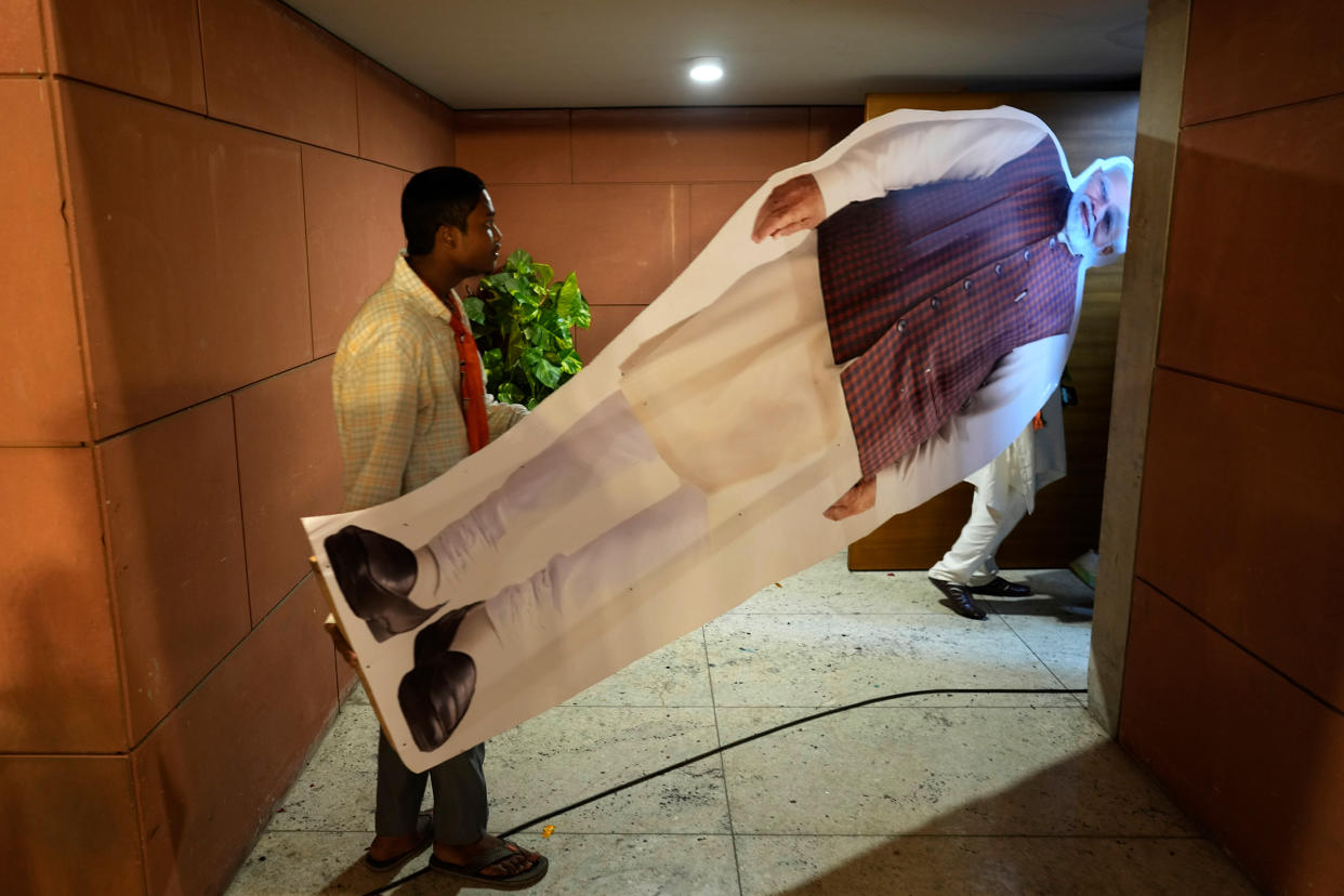 Workers carry a cutout of Modi at the party headquarters in New Delhi, June 4.<span class="copyright">Manish Swarup—AP</span>