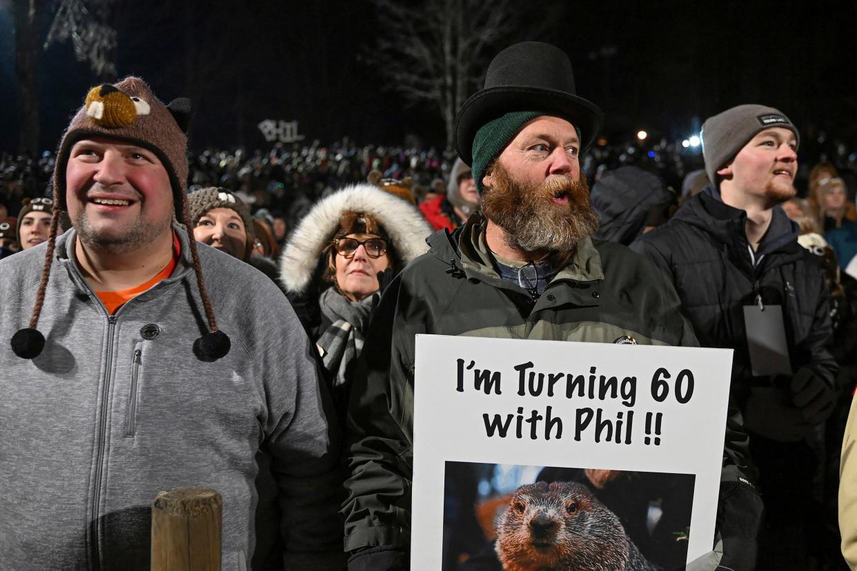 Rory Szwed, left, and Kent Rowan wait for Punxsutawney Phil to make his prediction on the 137th celebration of Groundhog Day in Punxsutawney, Pa.
