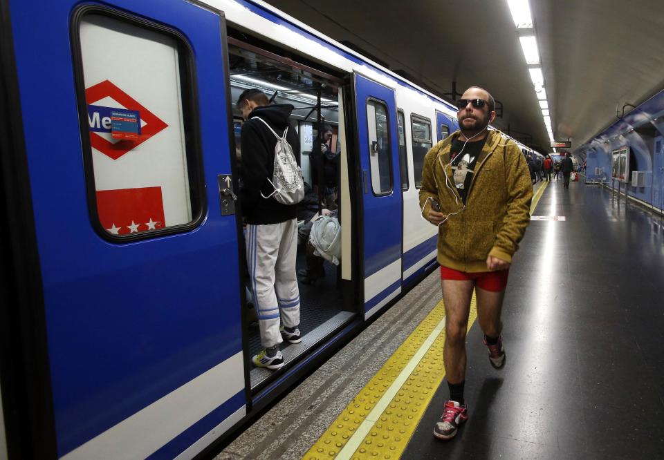 A passenger without his pants walks before taking a train during the "No Pants Subway Ride" event at a subway station in Madrid