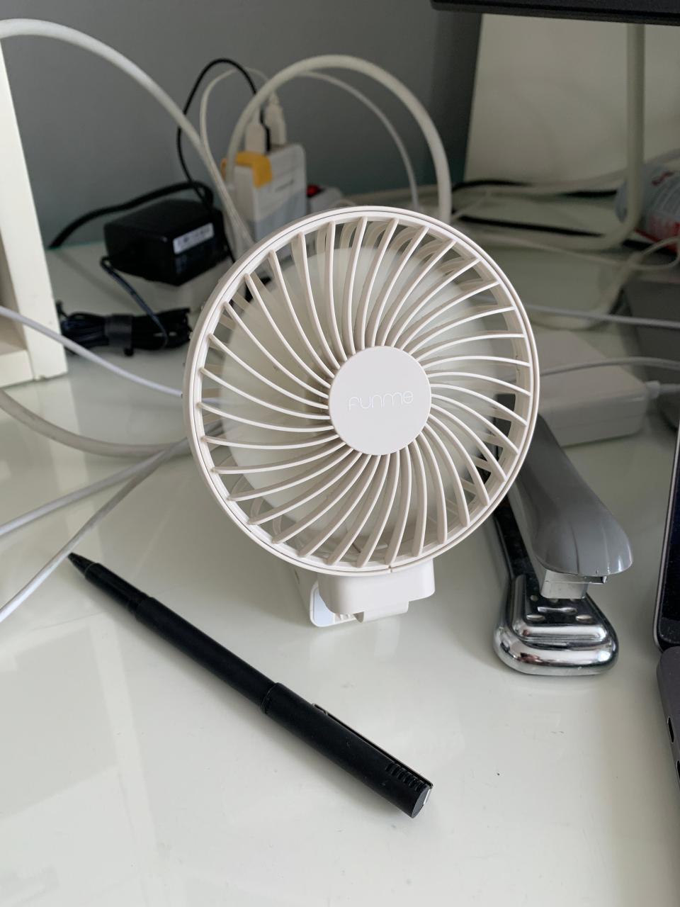 A small electric desk fan provides spot cooling without the energy drain of air conditioning.