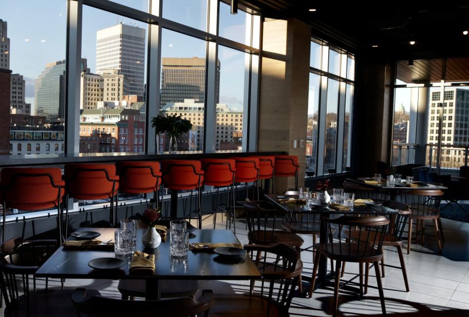 The modern dining room at Blu Violet has large walls of windows that offer views of downtown Providence.