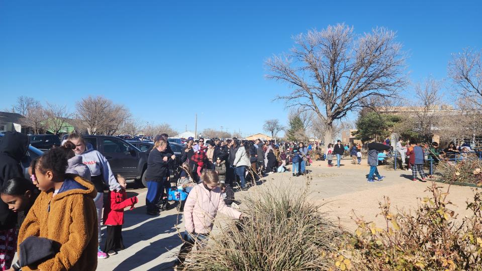 A line runs around the block Saturday at the 10th annual Northside Toy Drive held at the Palo Duro High School Gym in Amarillo.