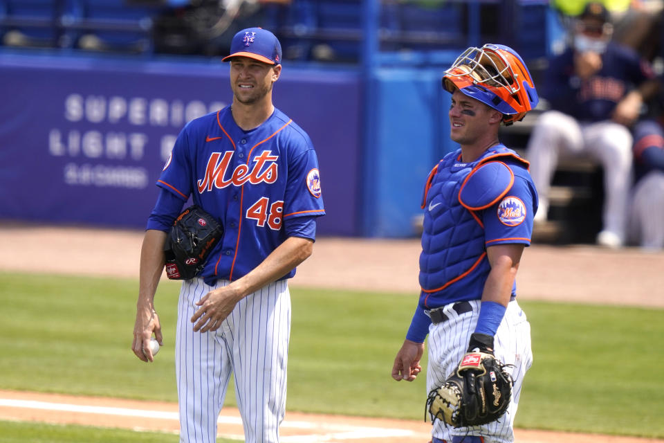 New York Mets starting pitcher Jacob deGrom (48) talks with catcher James McCann during the fourth inning of a spring training baseball game against the Houston Astros, Tuesday, March 16, 2021, in Port St. Lucie, Fla. (AP Photo/Lynne Sladky)