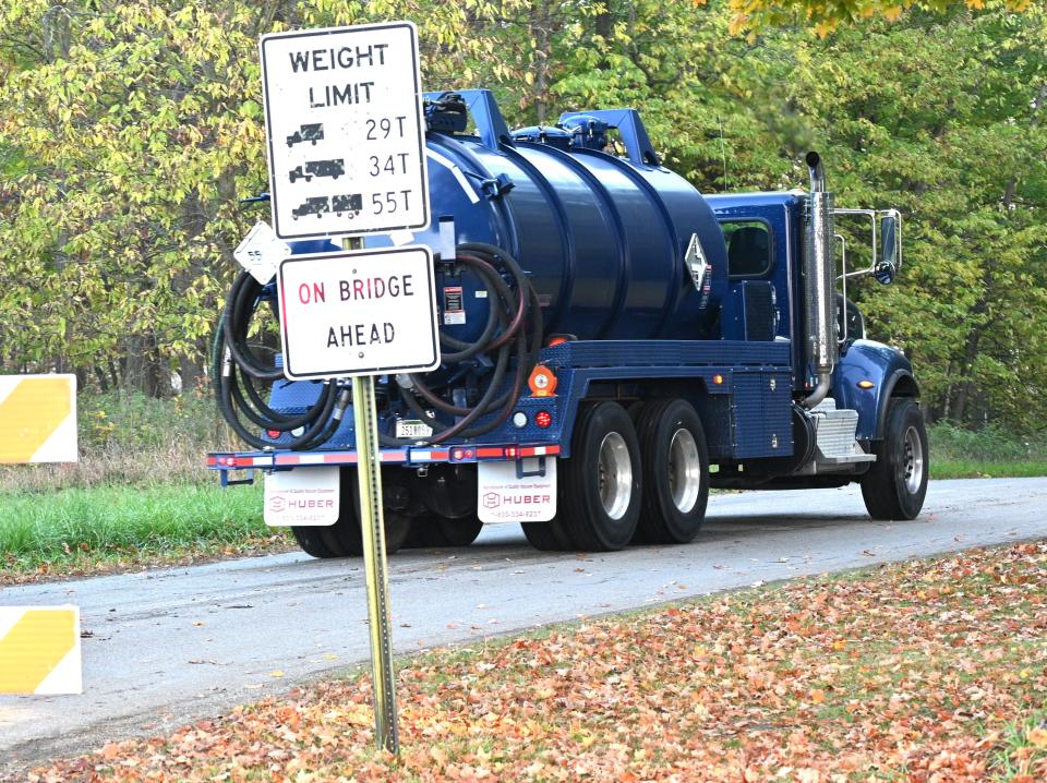A vacuum truck used to help remove gas and contaminated materials goes through a Michigan State Police barricade early Wednesday in Girard Township after a gasoline pipeline spilled about 8,400 gallons.
