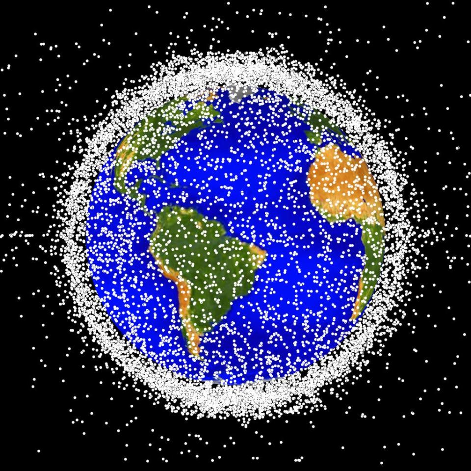 An illustration of thousands of dots around the Earth shows the density of satellites in the sky.