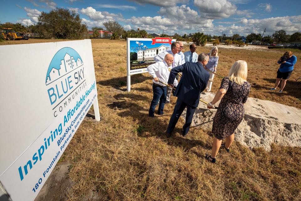 Attendees at the groundbreaking peruse the plans and the land for the new 88-unit affordable housing complex at 1st Street and Avenue S Northeast in Winter Haven.