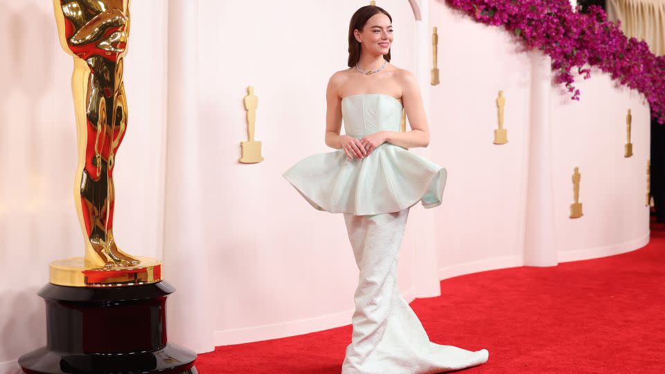 Emma Stone, nominated as Best Actress for her performance in “Poor Things,” wore a custom Louis Vuitton gown with a flared peplum waist and shell detailing. - Christina House/Los Angeles Times/Getty Images