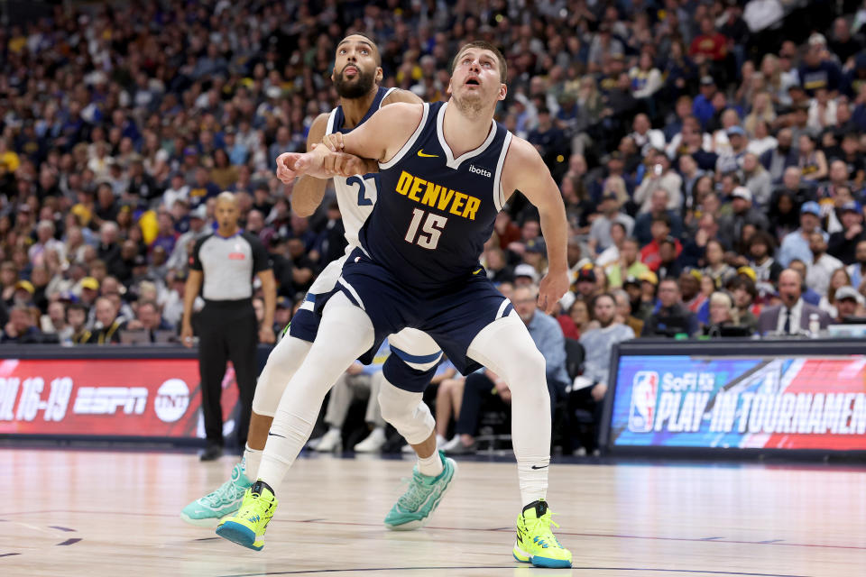 DENVER, COLORADO - APRIL 10: Nikola Jokic #15 of the Denver Nuggets boxes out Rudy Gobert #27 of the Minnesota Timberwolves during the third quarter at Ball Arena on April 10, 2024 in Denver, Colorado. NOTE TO USER: User expressly acknowledges and agrees that, by downloading and or using this photograph, User is consenting to the terms and conditions of the Getty Images License Agreement.  (Photo by Matthew Stockman/Getty Images)