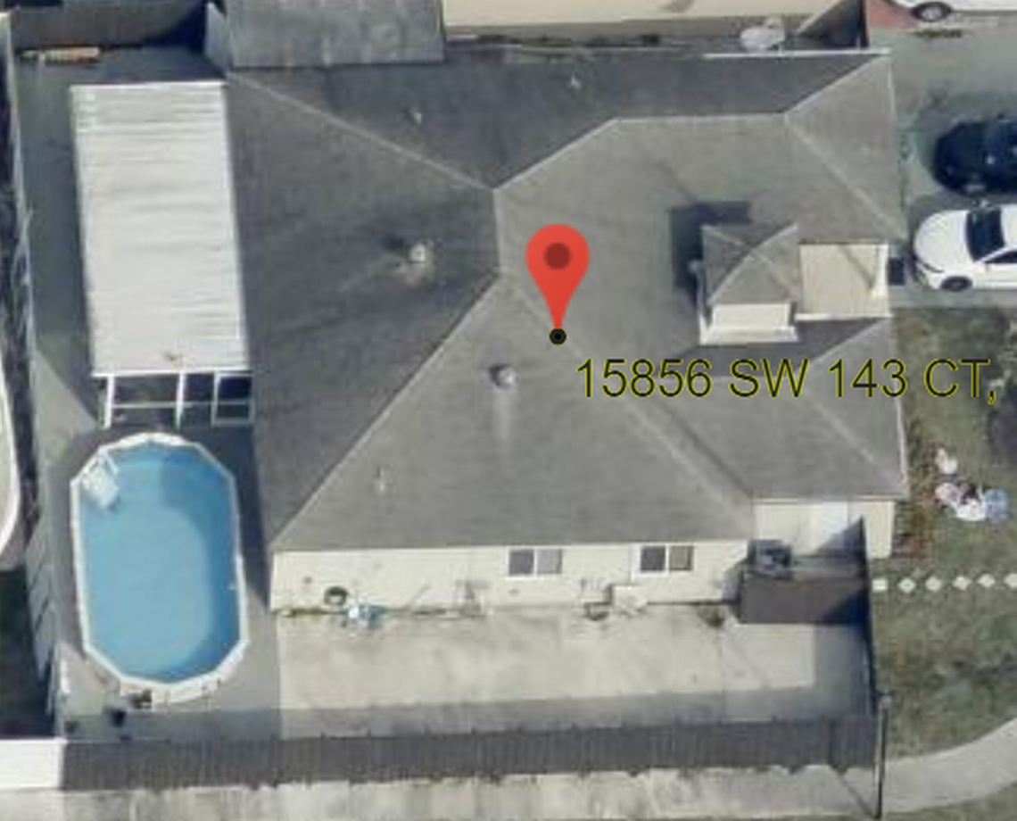 The Jan. 2, 2023 overhead shot of 15856 SW 143rd Ct. from the north side shows a small fence added in front of the side door and pavers put down toward a gate.