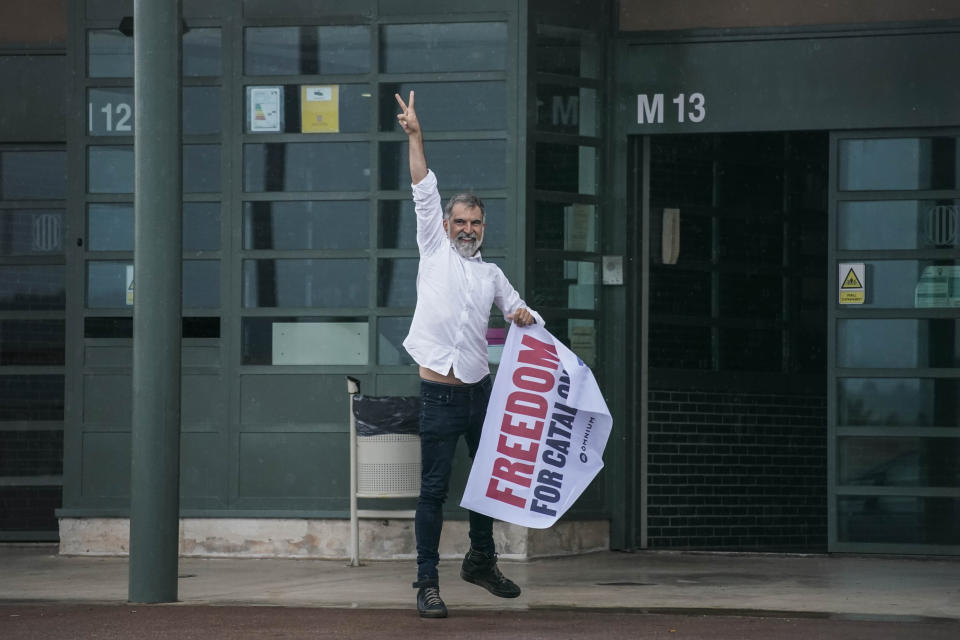 Jordi Cuixart, one of the Catalan leaders imprisoned for their role in the 2017 push for an independent Catalan republic, makes the victory sign at Lledoners prison in Sant Joan de Vilatorrada, near Barcelona, Spain, Wednesday, June 23, 2021. Nine separatists pardoned by the Spanish government are expected to leave the prisons where they were serving lengthy terms for organizing a bid for an independent northeastern Catalonia region nearly four years ago. Spain's official gazette published earlier in the day the government decree pardoning them. (AP Photo/Joan Mateu)