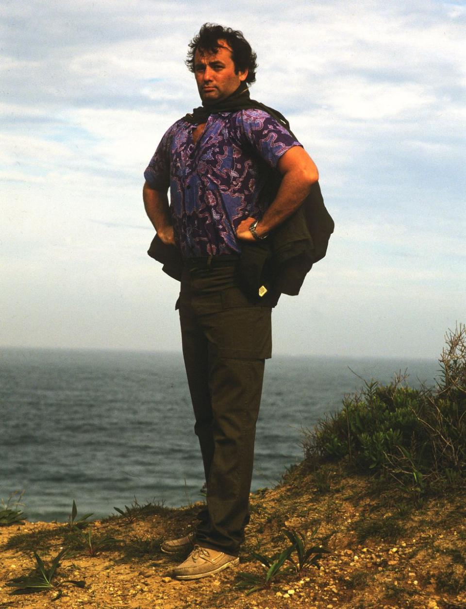 <p>Bill Murray gazes over a seaside cliff-edge during a photoshoot for <em>Rolling Stone</em> magazine in 1981. </p>