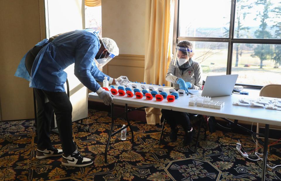 Dexton Cummings, left, and Mackenzie Garcia go through the process of antigen testing at Patriot Hills Golf Course in Stony Point on Tuesday, January 4, 2022. 