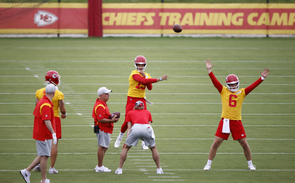 Kansas City Chiefs quarterback Patrick Mahomes throws the ball downfield as backup quarterback Shane Buechele (6) stands on the line during a morning workout at the team's NFL football training camp facility at in St. Joseph, Mo., Sunday, July 24, 2022. (AP Photo/Colin E. Braley)
